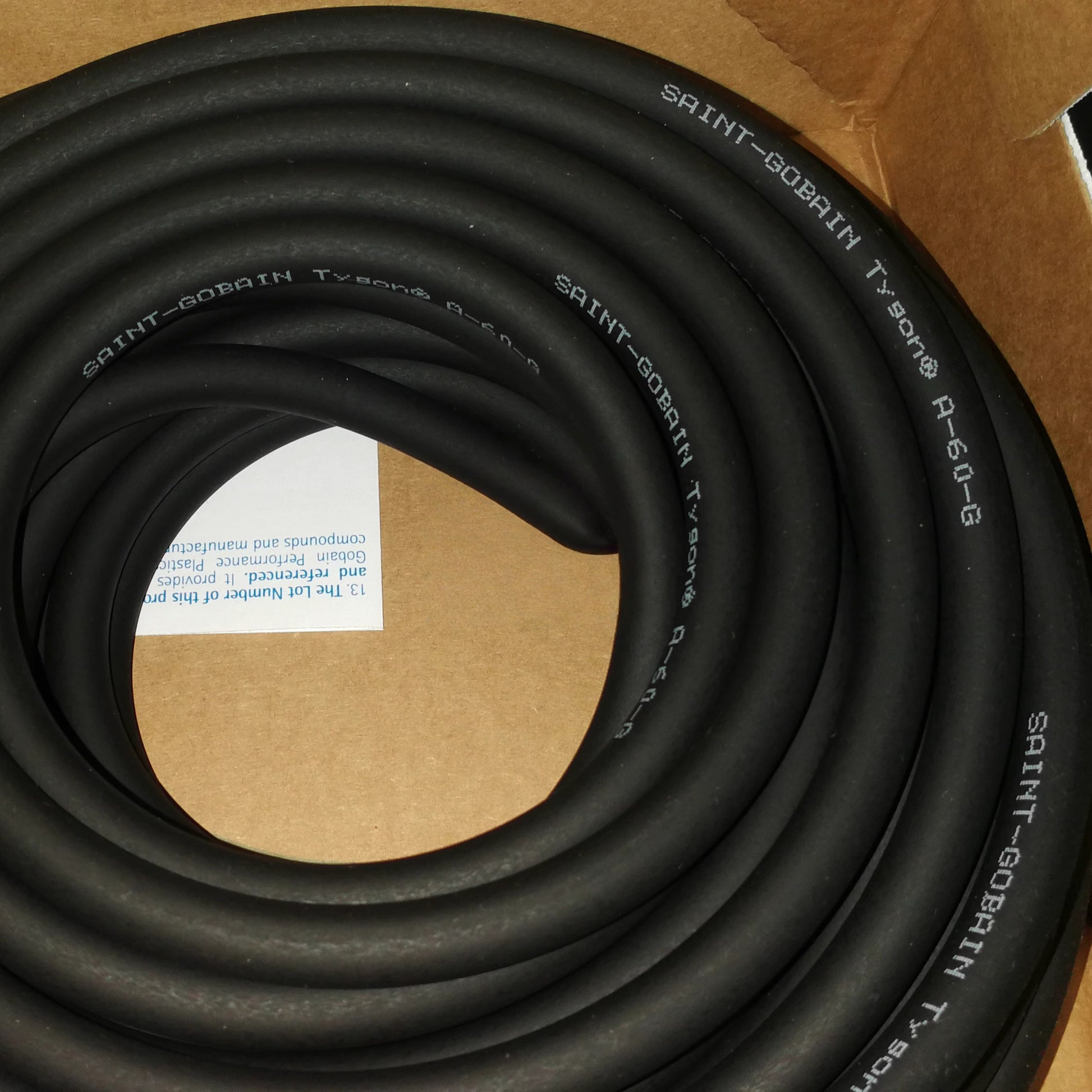 Saint-Gobain Tygon Norprene A-60-G black industrial tubing coil with brand label, -60 to 135°C temperature resistant peristaltic pump hose
